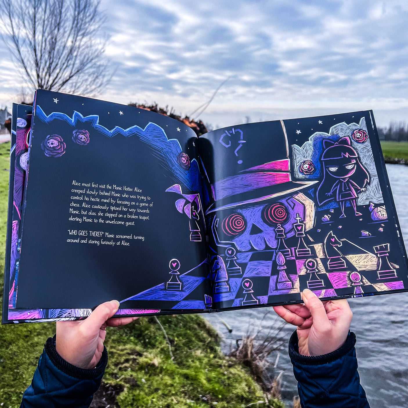 Open gothic storybook showing horror-inspired Wonderland artwork and text